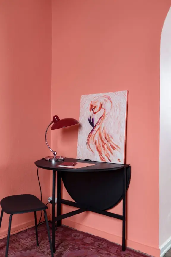 living room painted with bright pink accent wall