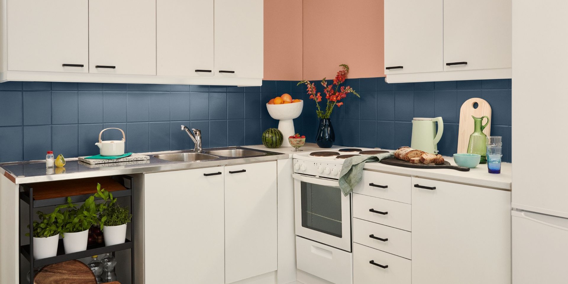 white kitchen with blue painted backsplash tiles