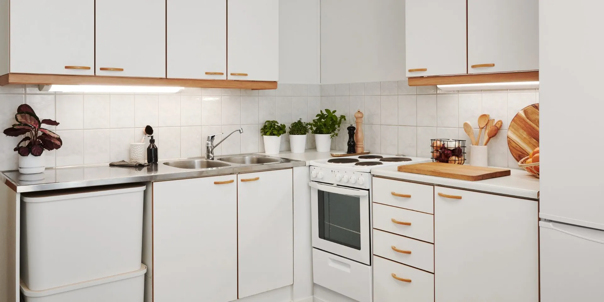 dated kitchen with white cabinet and wooden colour trim