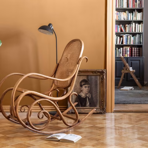 earthy yellow wall colour in living space with rocking chair 