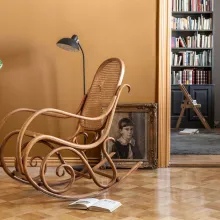 earthy yellow wall colour in living space with rocking chair 