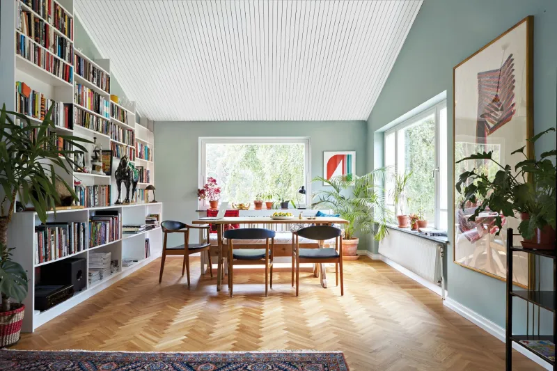 spacious living room with soft green colour wall