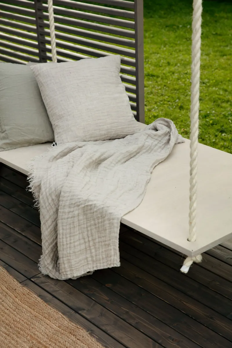 beige colour sunbed on dark wooden terrace