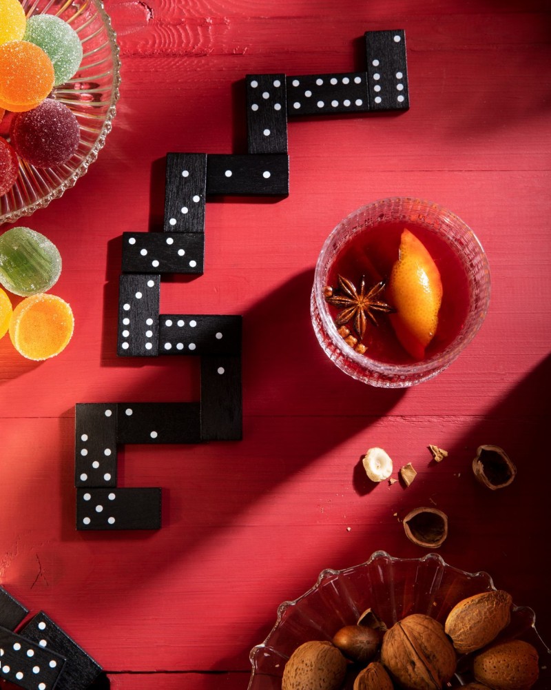 red colour table with Christmas treats and Domino game